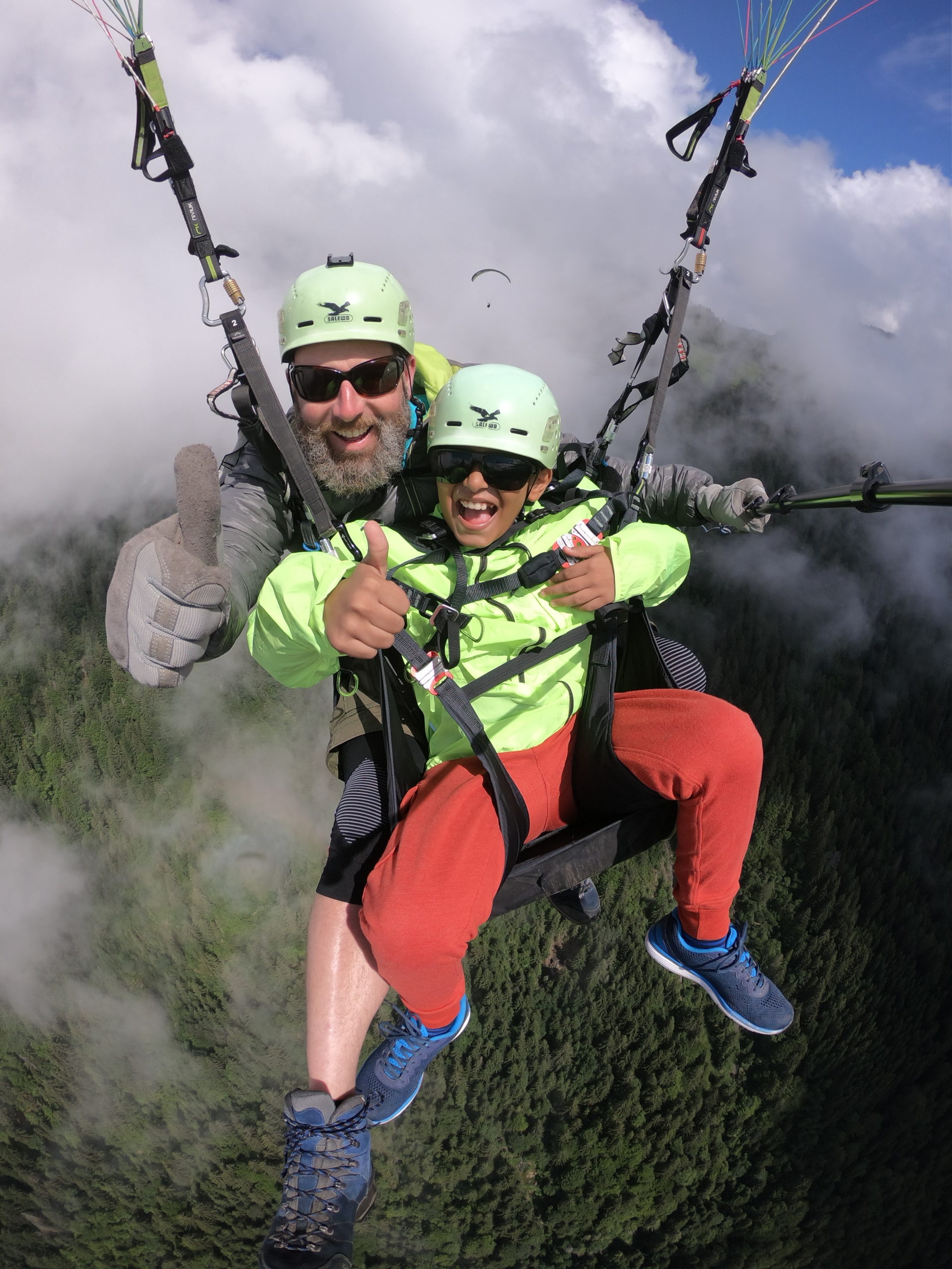 Paragliding with kids Interlaken big smiles thumbs up - Copy
